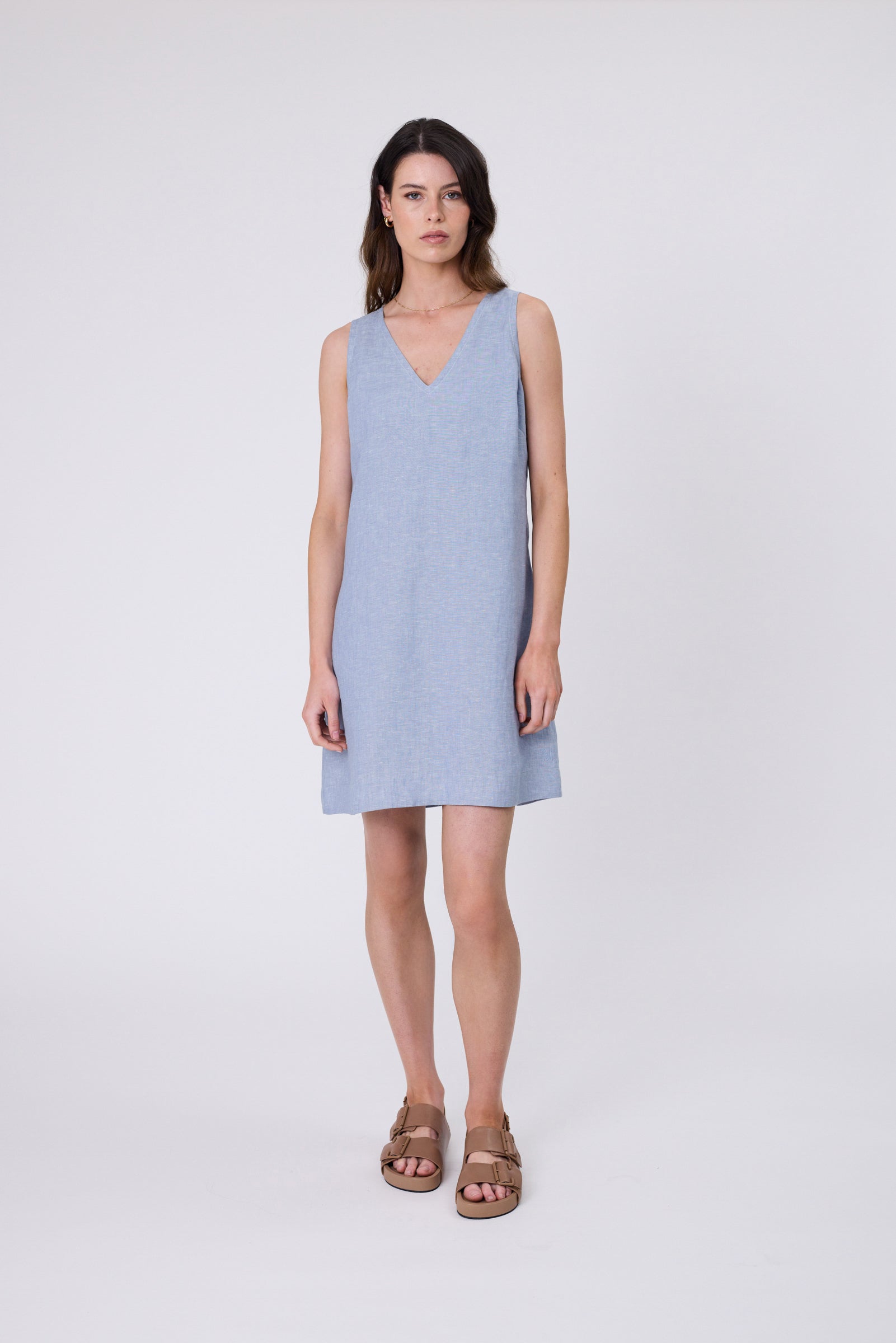 Luna Linen Dress in Black — European linen A-line mini with V-neckline, contrast stitching, and side pockets. Designed in New Zealand.